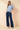 Full-length view of model wearing blue Round Neck Puff Short Sleeve Cable Sweater with blue jeans