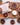 Shower Steamers - Wrapped Singles on a wooden board surrounded by dried citrus slices.