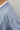 Close-up detail of  blue long sleeve top