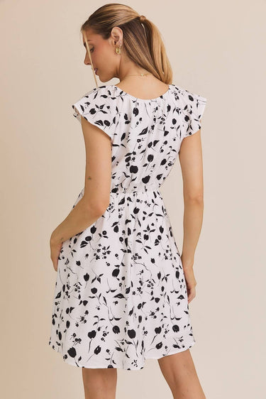 BACK VIEW OF ROUND NECK RUFFLE SHORT SLEEVE FLORAL PRINT DRESS ON MODEL