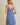 Model wearing SURPLICE S.P.G STRAP FALRE HEM DITSY MINI DRESS from the back, showcasing its floral design.