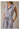 V NECK CAP SLEEVE BUTTON UP WAIST TIE BELT MIDI DRESS worn by a model with pockets and a stylish collar.