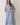 Embroidered Floral Tiered Button Down Midi Dress displayed on a model with a blue floral design and tiered skirt.