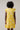 Back view of a model wearing the Joni Floral Yodi Shift Mini Dress in yellow floral print with ruffle sleeves.