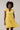 Joni Floral Yodi Shift Mini Dress on model, showcasing ruffle sleeves and floral pattern in vibrant yellow.