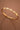 18K Gold PVD Plated Waterproof Stainless Steel Bangle displayed in a curved view on a brown background