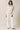 Full-length view of model wearing beige melange Half Zip Funnel Neck Long Sleeve Pullover Top with matching pants