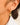 Dainty round stone dangle earrings close-up