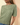 Close-up view of model wearing sage green ribbed knit top