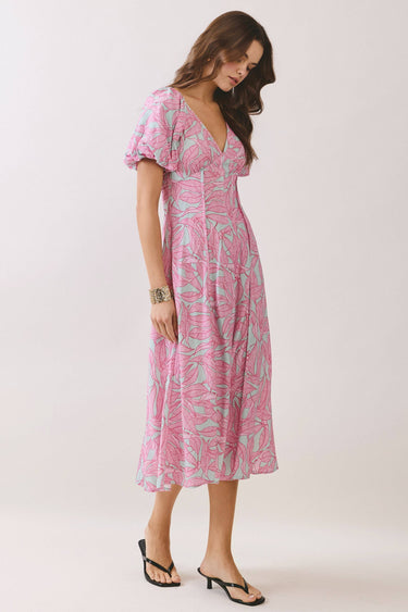 Pink Tropical Print Puff Sleeve Midi Dress on a model with puff sleeves and a V-neckline, featuring a tropical leaf design.