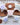 Shower Steamers - Wrapped Singles displayed on a wooden board with dried herbs and citrus slices.