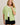 Model wearing green short sleeve sweater cardigan with black shorts