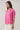 Mirany Ikat Bindy Puff Sleeve Top featuring pink ikat print, puff sleeves, and ruffle neckline.