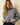 Full-length view of model wearing gray striped round neck long sleeve sweater with black pants