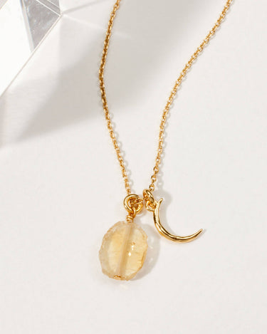 Celestial Being Necklace- Citrine featuring a citrine stone and gold crescent charm, adjustable length.