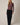 Full-length view of model wearing burgundy Mock Neck Long Sleeve Button Up Top with black pants
