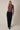 Full-length view of model wearing burgundy Mock Neck Long Sleeve Button Up Top with black pants