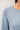 Close-up of blue slub pullover sweater fabric and raglan sleeve detail