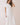 Classic Shirt Collar Neck Pleated Detail Dress worn by a model, showcasing a midi length and pleated hem detail.