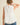 Back view of the Pleated throughout Sleeveless A Line Top featuring a keyhole closure and layered pleated hem.