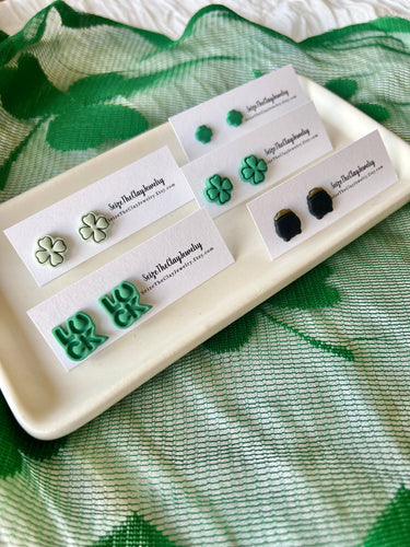 Clover Studs Shamrock Earrings Pot of Gold Studs displayed on a tray with green background.