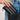 Jocelyn Wallet Tan Card Holder being placed in a stylish black handbag, showcasing its woven texture and elegance.