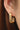 18K Gold Plated Waterproof Stainless Steel Hoop Earrings 7376 worn on an ear showing the gold finish