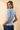 Back view of model wearing blue Round Neck Puff Short Sleeve Cable Sweater with blue jeans