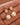 18K Gold PVD Plated Waterproof Stainless Steel Drop Earrings 7774 displayed as a pair against a brown background