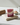 Red Feathers Organic Artisan Soap bar displayed on a decorative surface