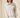 Shop Wall beige melange knit pullover with a funnel neckline and half-zip closure worn by a model