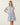 Shop Wall printed mini dress with blue floral pattern, notch neckline, and flutter sleeves on a blonde model