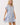 Shop Wall printed mini dress with blue floral pattern, notch neckline, and flutter sleeves on a blonde model