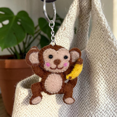 Monkey with Banana Felt Wool Keychain hanging from a bag