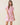 Model wearing a Shop Wall pink floral print woven mini dress with a collared neckline and elasticized waist.