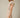 Shop Wall model wearing a beige and white striped notch neck short sleeve mini dress with a smocked waist