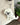 Bichon Puppy Dog Felt Wool Keychain hanging from a textured cream bag
