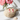 Mini Valentines Studs with red heart details styled beside pink flowers